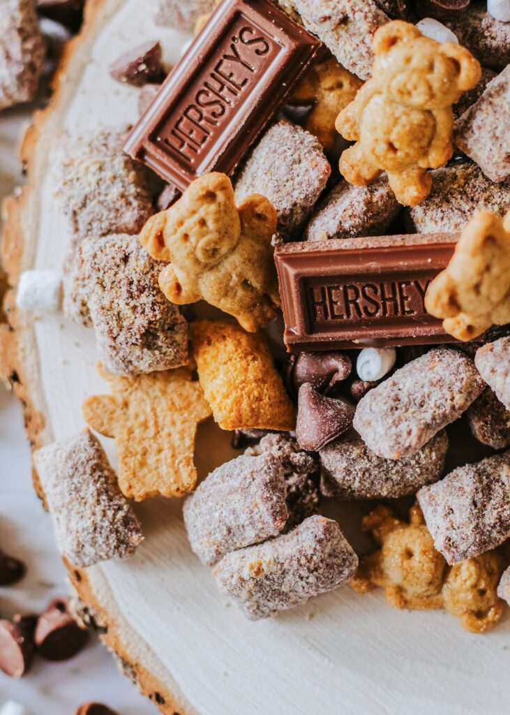 s'mores muddy buddies with teddy grahams, chocolate bars and coated cereal