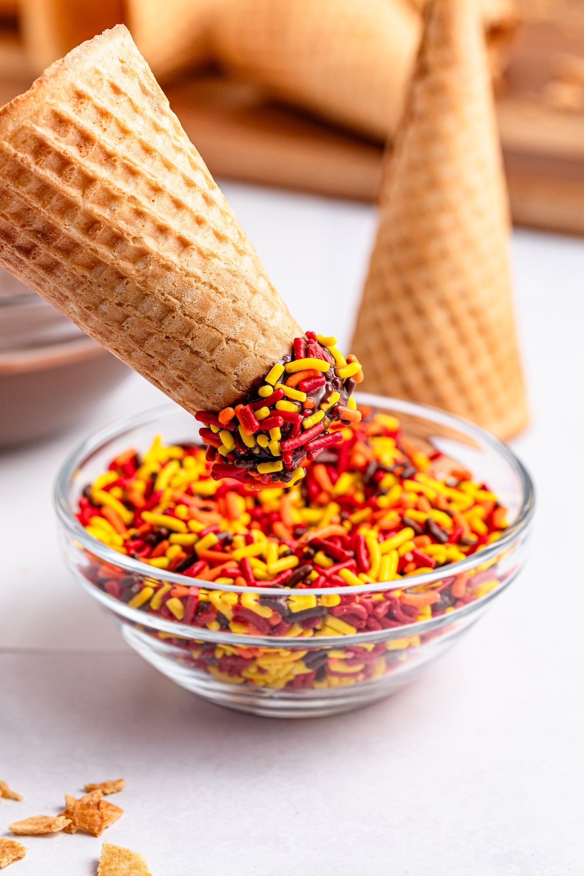 dipping the cone into sprinkles