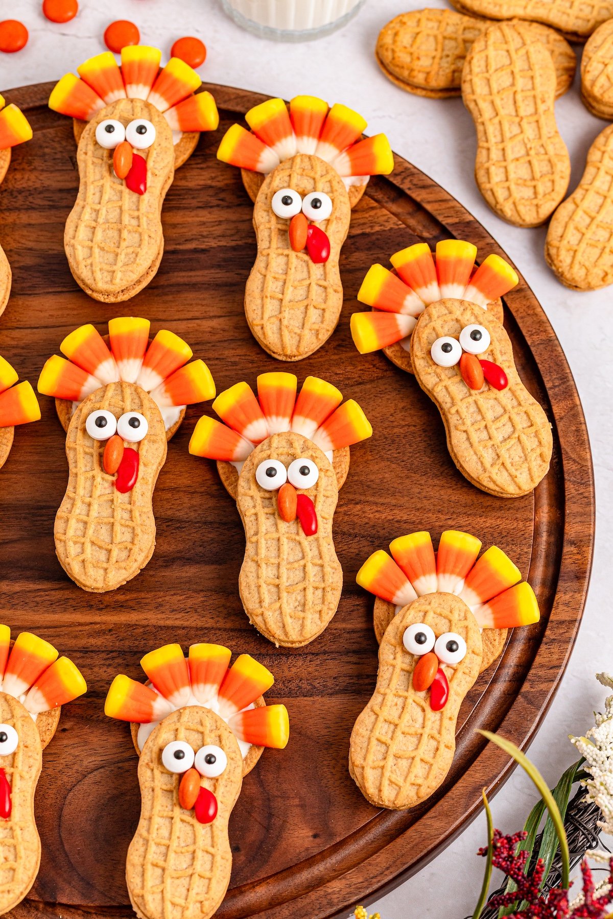 nutter butter turkey cookies on a brown board