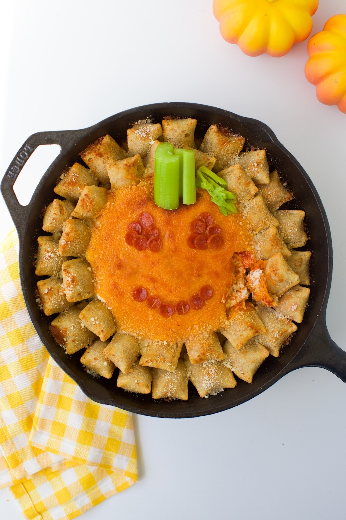 Over the top view of baked Jack-O'-Lantern Dip in a skillet. 