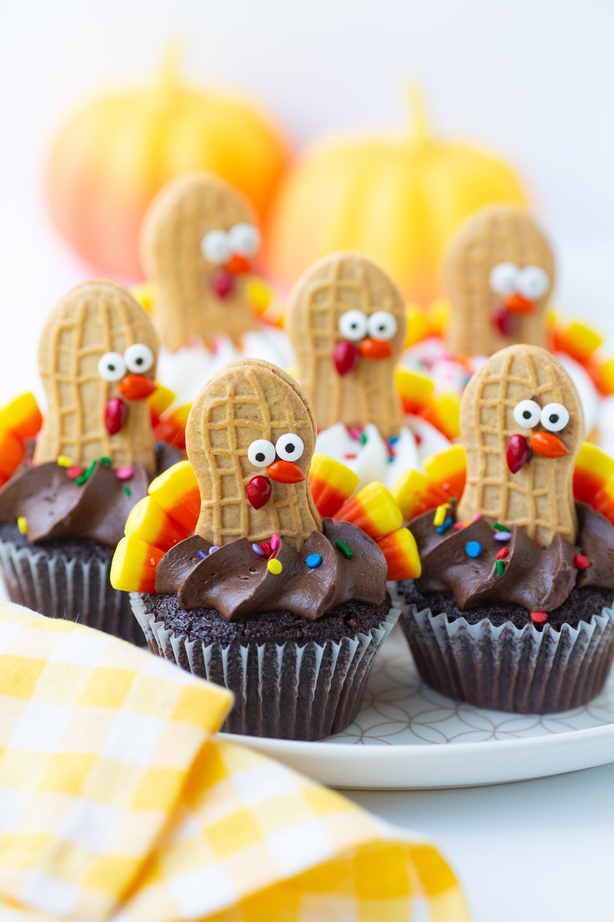 Nutter Butter Turkey Cupcakes on a plate with a cloth napkin nearby