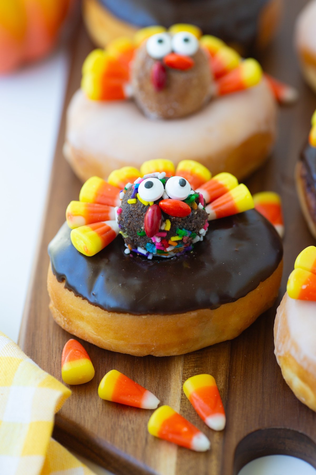 Chocolate Glazed Candy Corn Turkey Donuts with Chocolate Sprinklle Donut Holes on a serving tray. 