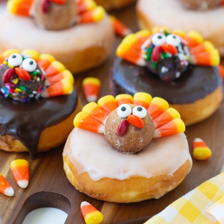 Up close view of Candy Corn Turkey Donuts on a wooden serving tray,.