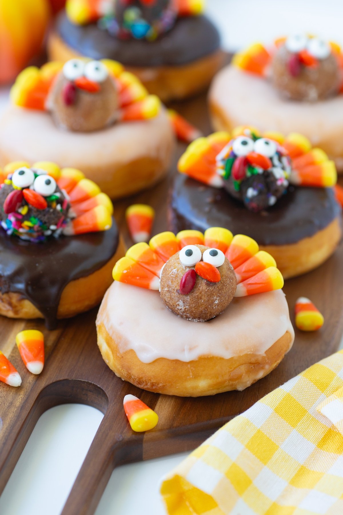 Up close view of Candy Corn Turkey Donuts on a wooden serving tray,.