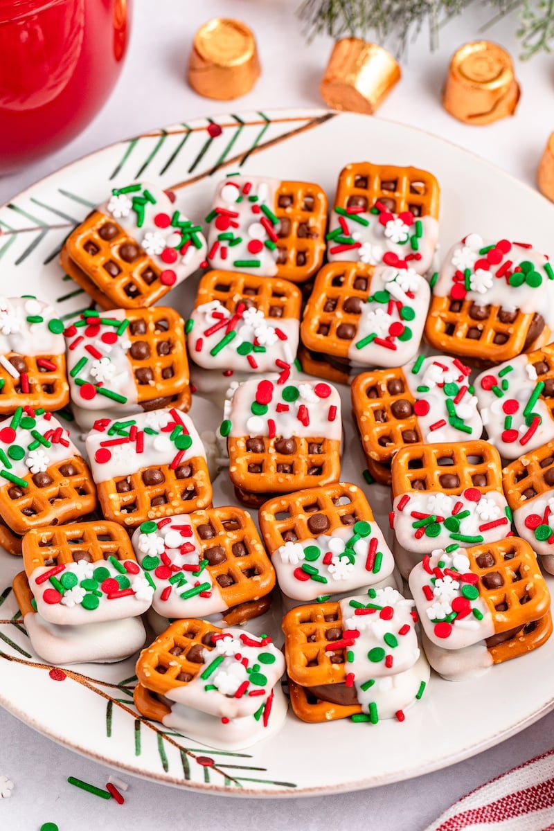 pretzels dipped in white chocolate on a white plate