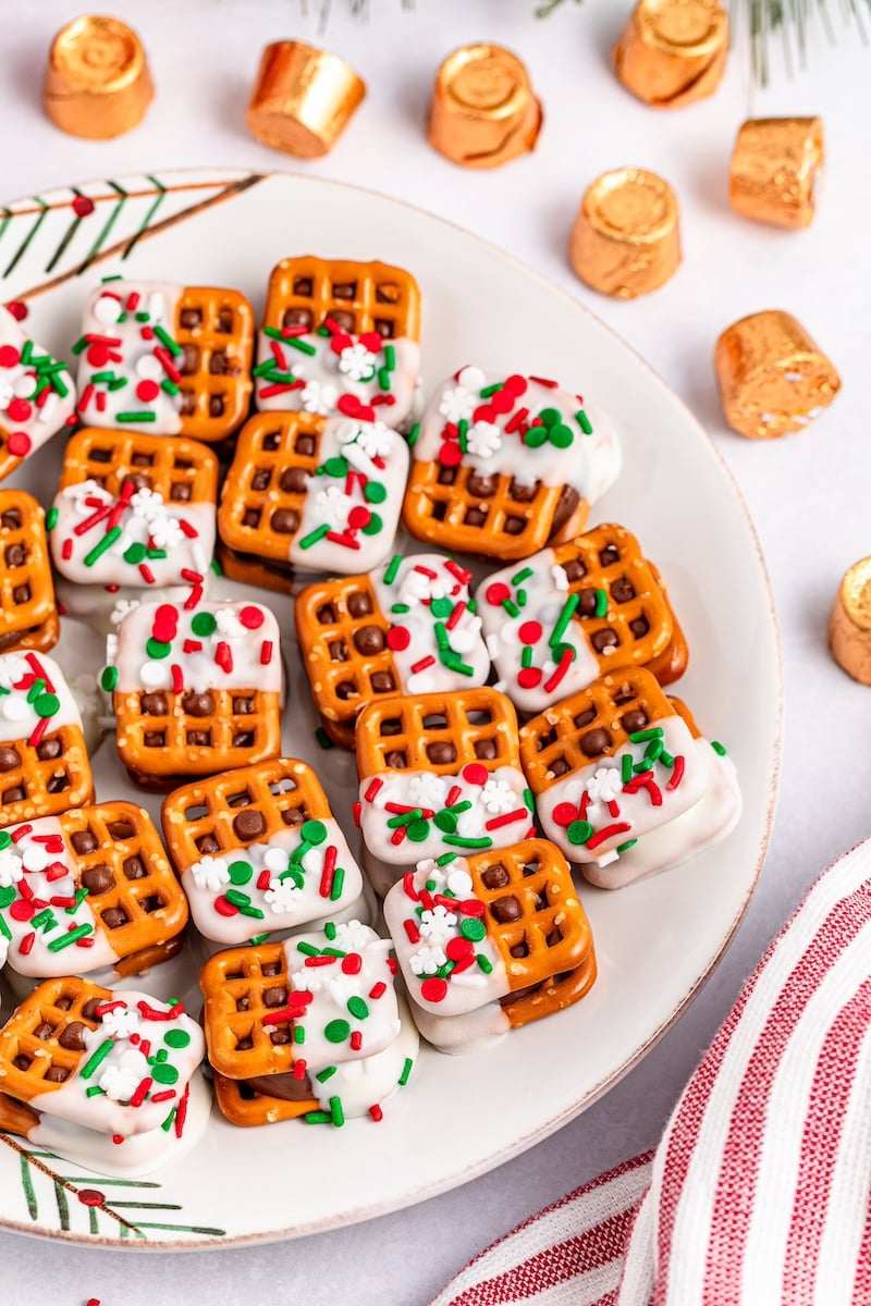 pretzels dipped in white chocolate on a white plate