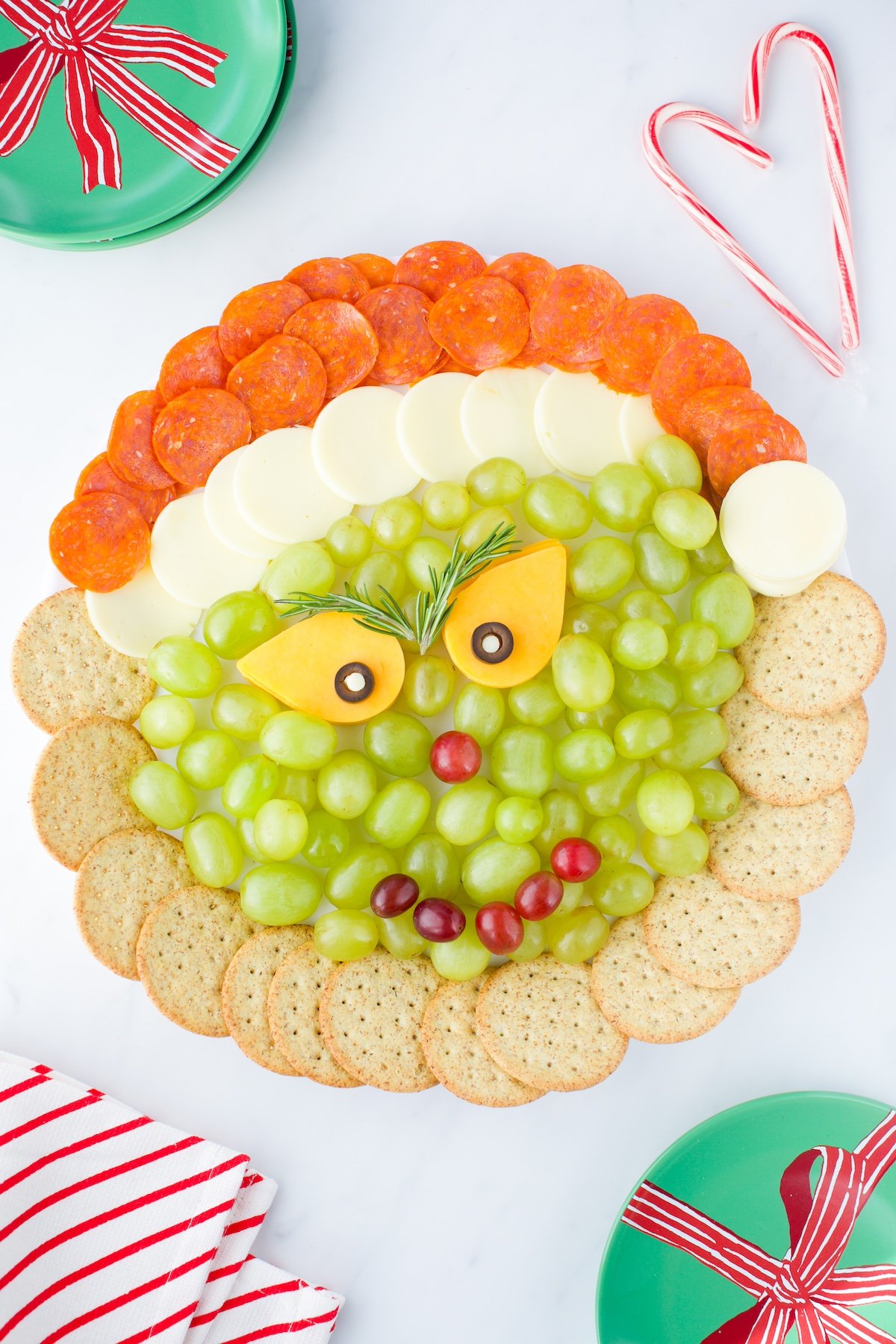 Grinch Cheese Platter with fruit, grapes and cheese for movie nights.