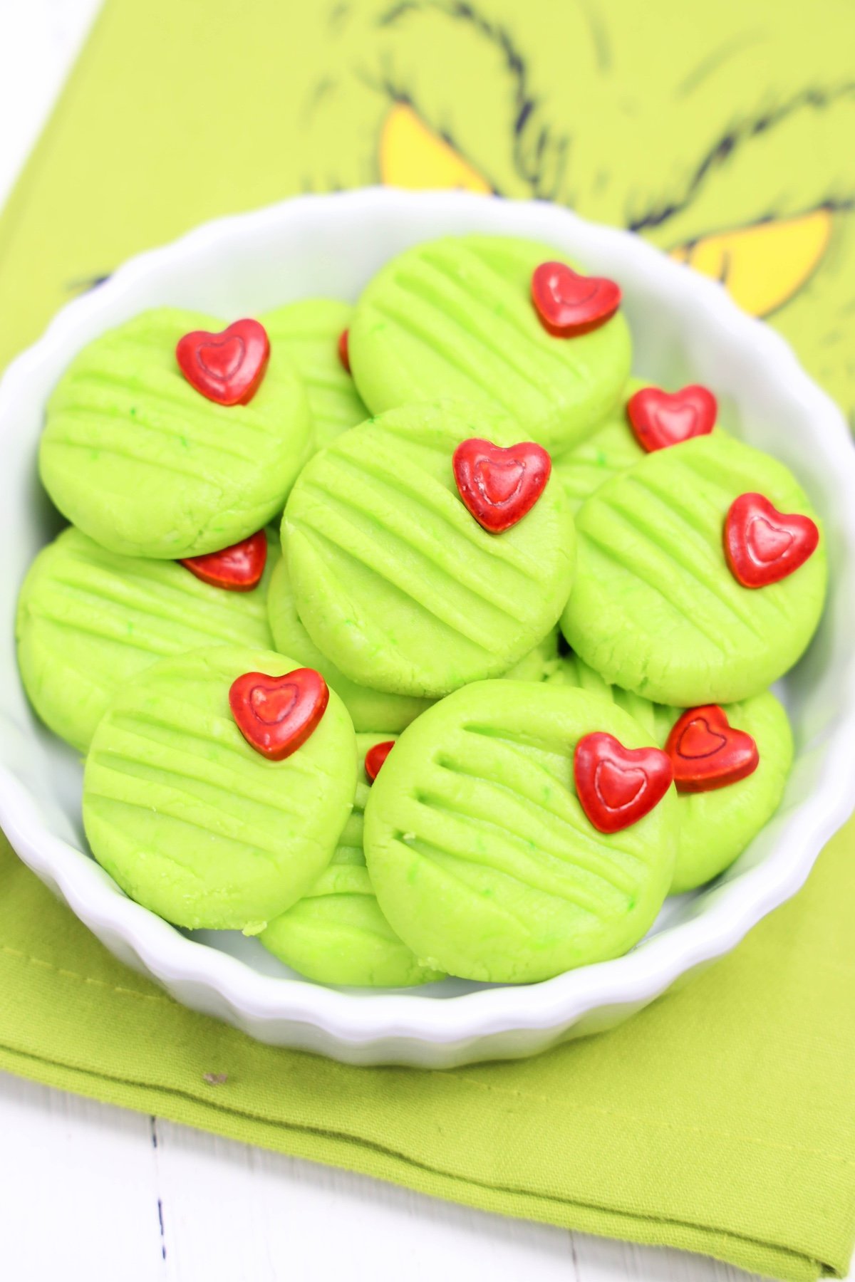 Grinch cream cheese mints in a white bowl