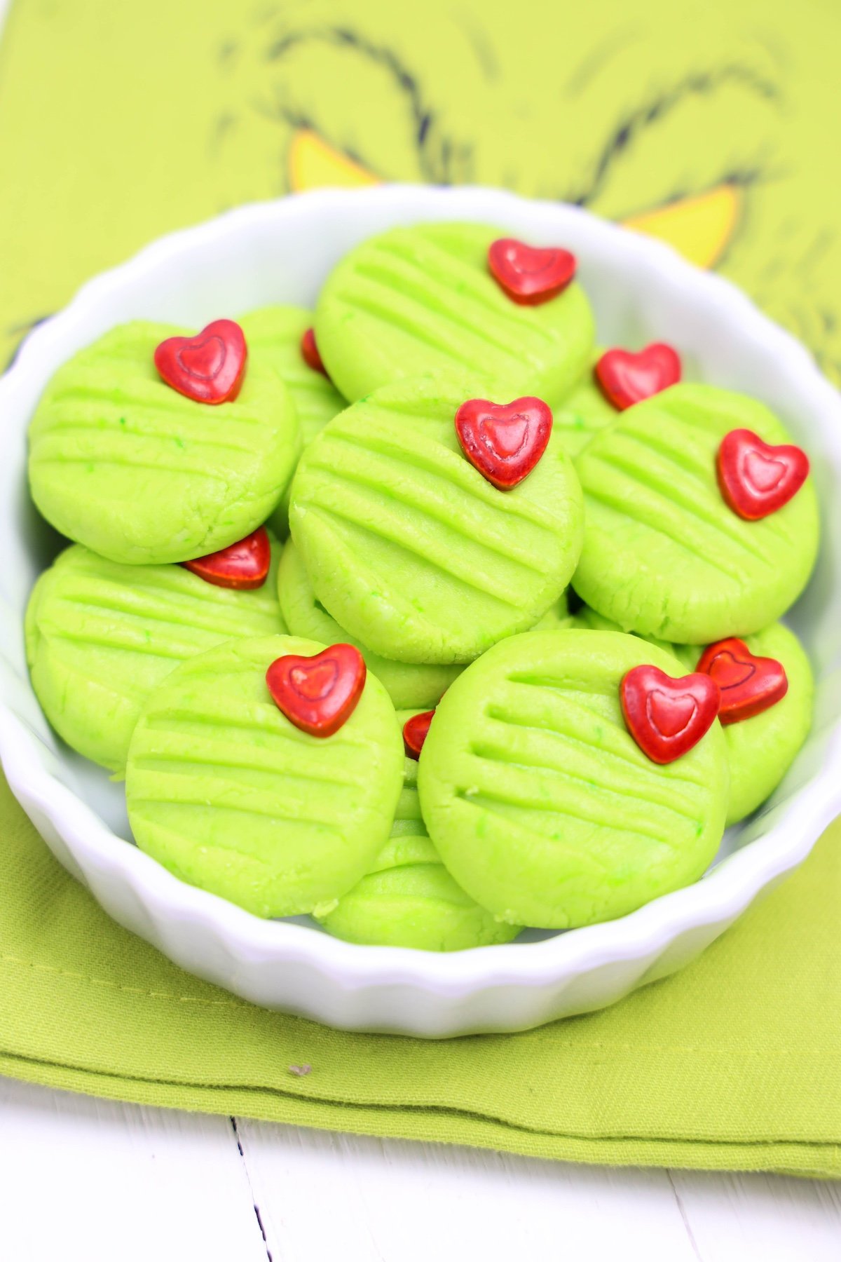 Grinch cream cheese mints in a white bowl