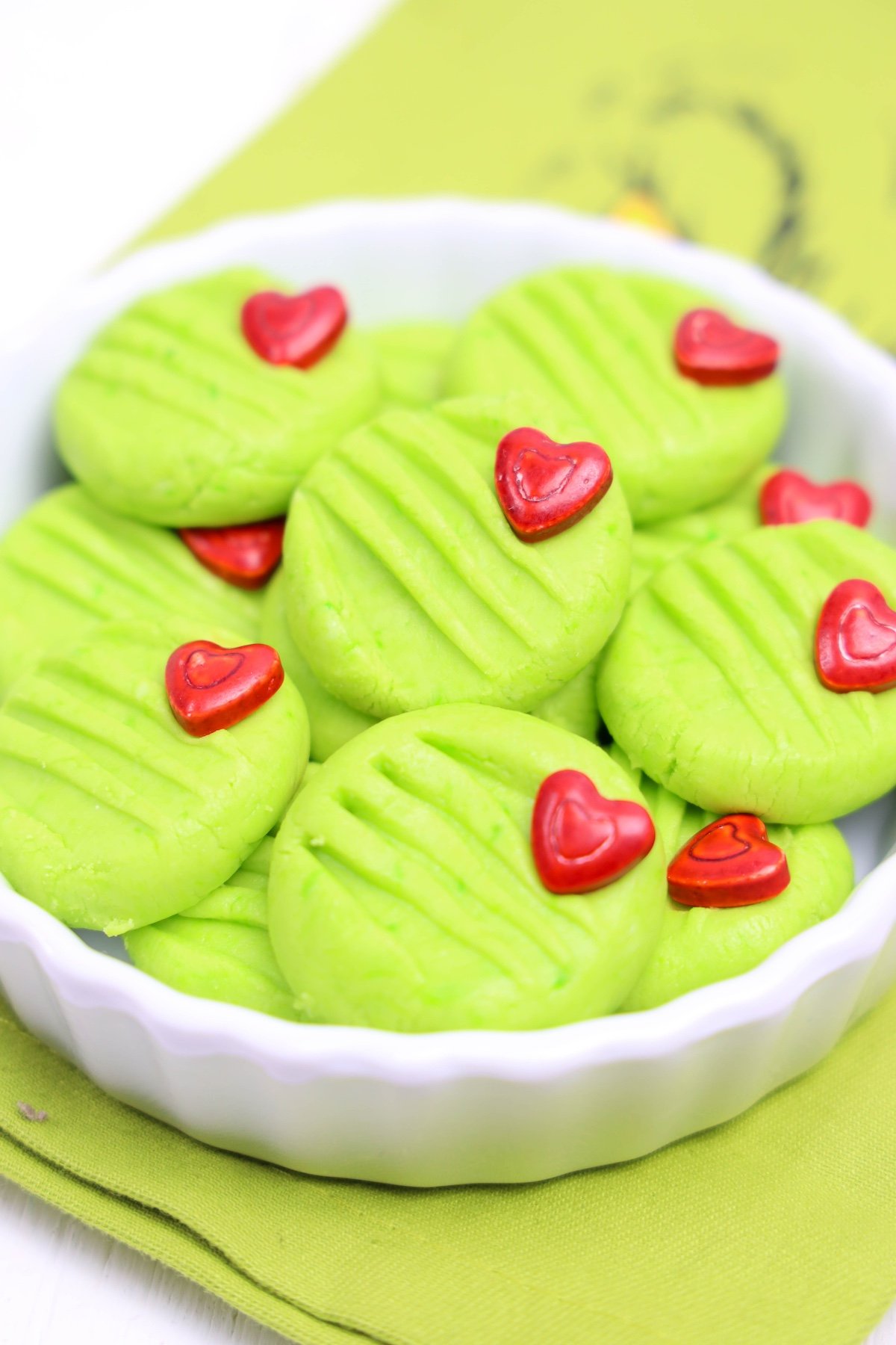 Grinch cream cheese mints in a white bowl