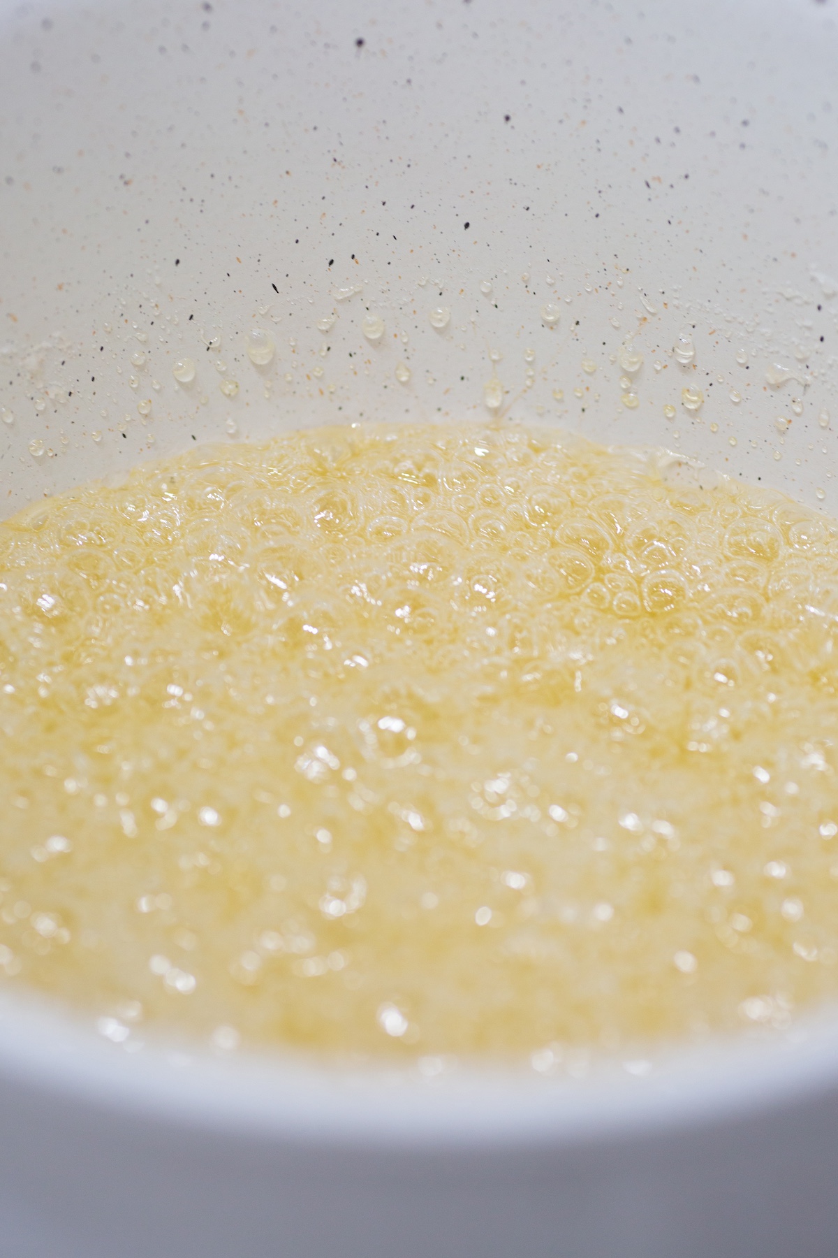 sugar syrup boiling in pot to make candied fruit snacks.