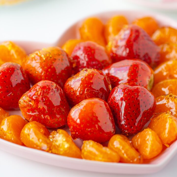 candied fruit snacks plated. candied strawberries, candies clementines.