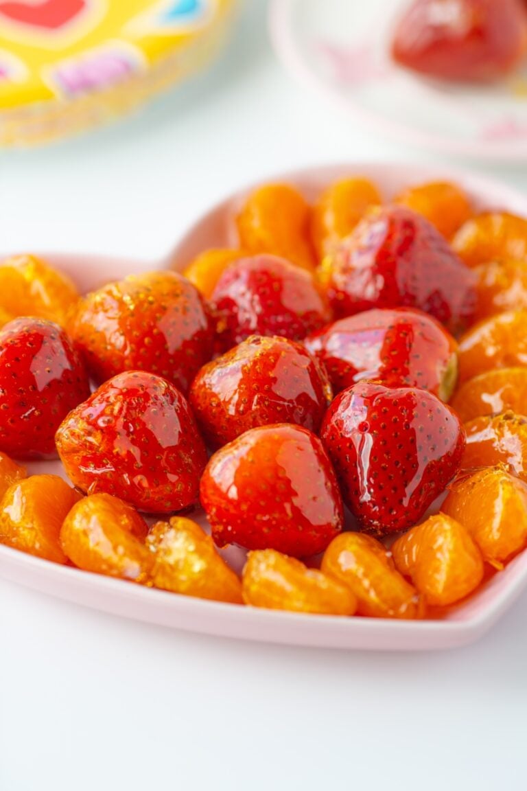 candied fruit snacks plated. candied strawberries, candies clementines.