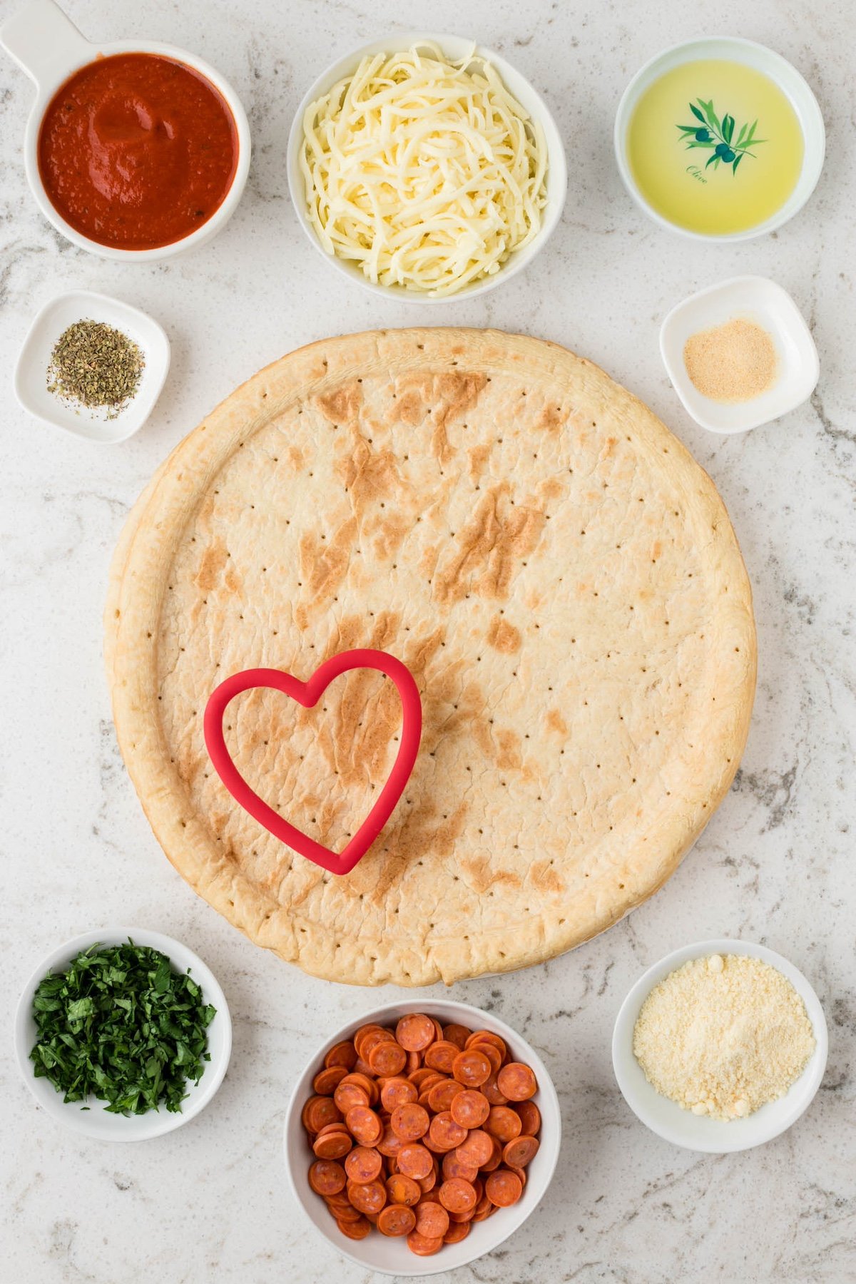 using a cookie cutter to cut the pizza dough