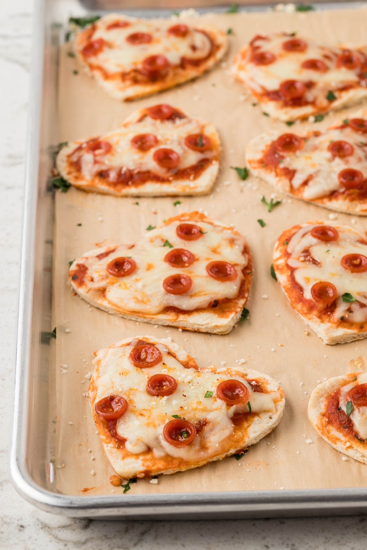 heart mini pizzas on a tray