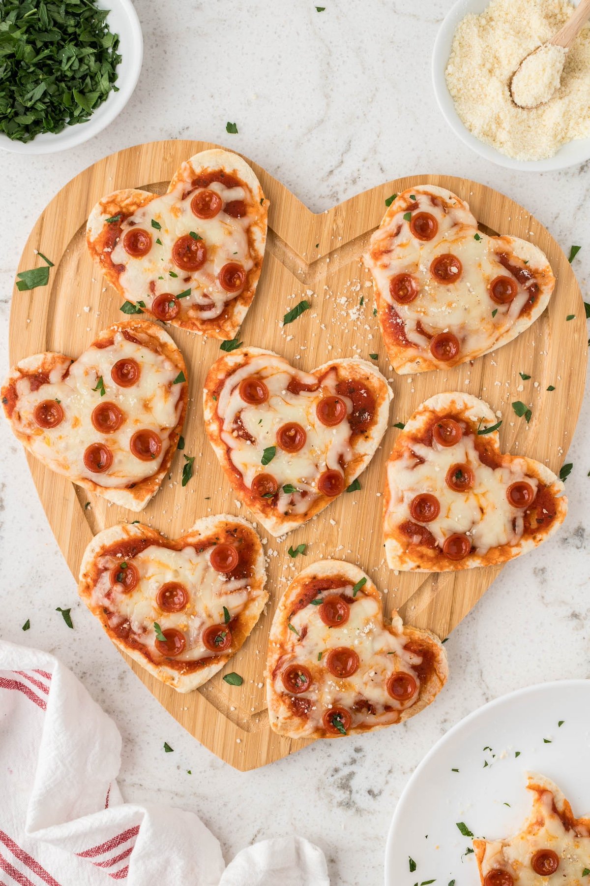 heart mini pizzas on a brown tray