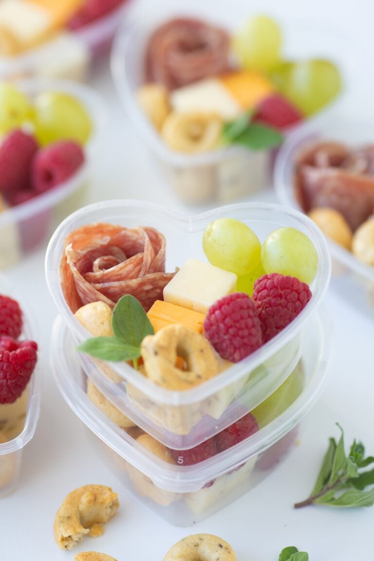 This Mini Heart Charcuterie Box boasts a delightful mix of fresh berries, creamy cheeses, and savory salami—all nestled in a heart-shaped display of love.