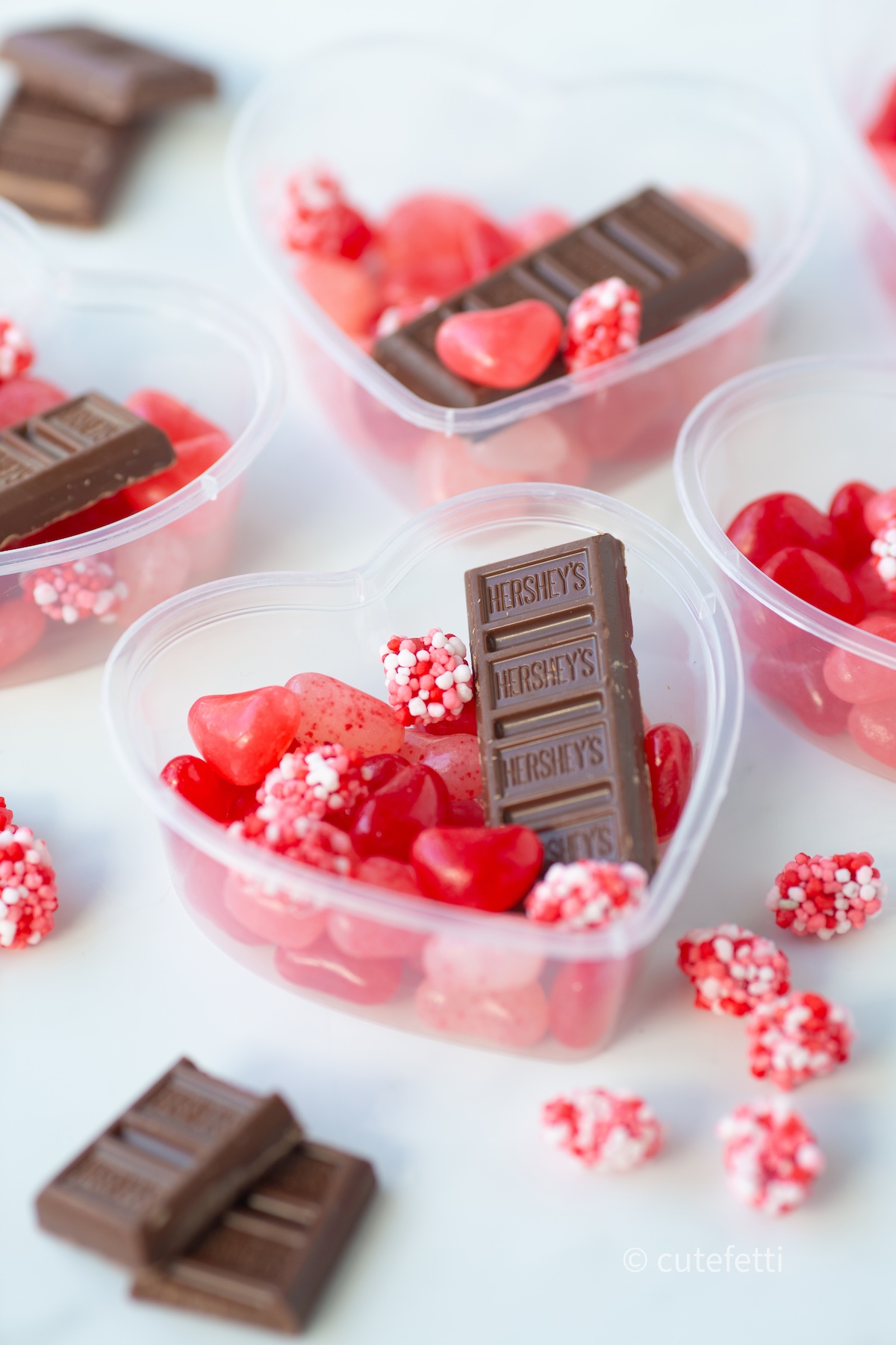 candy filled heart charcuterie box containers. hershey chocolate, heart shaped jelly beans and nerds clusters.