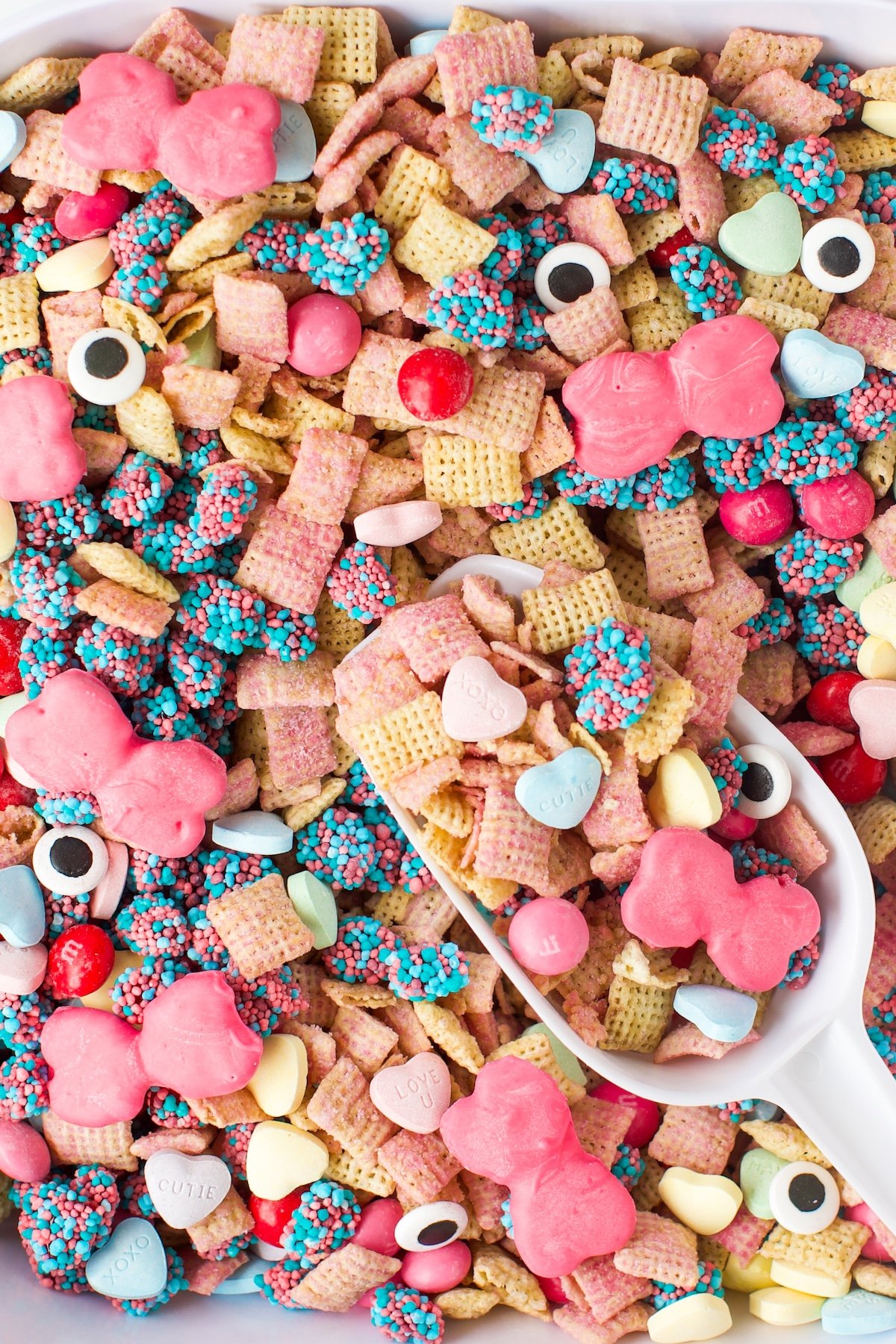 pretty Monster High Snack Mix with bright pink bow pretzels being scooped.