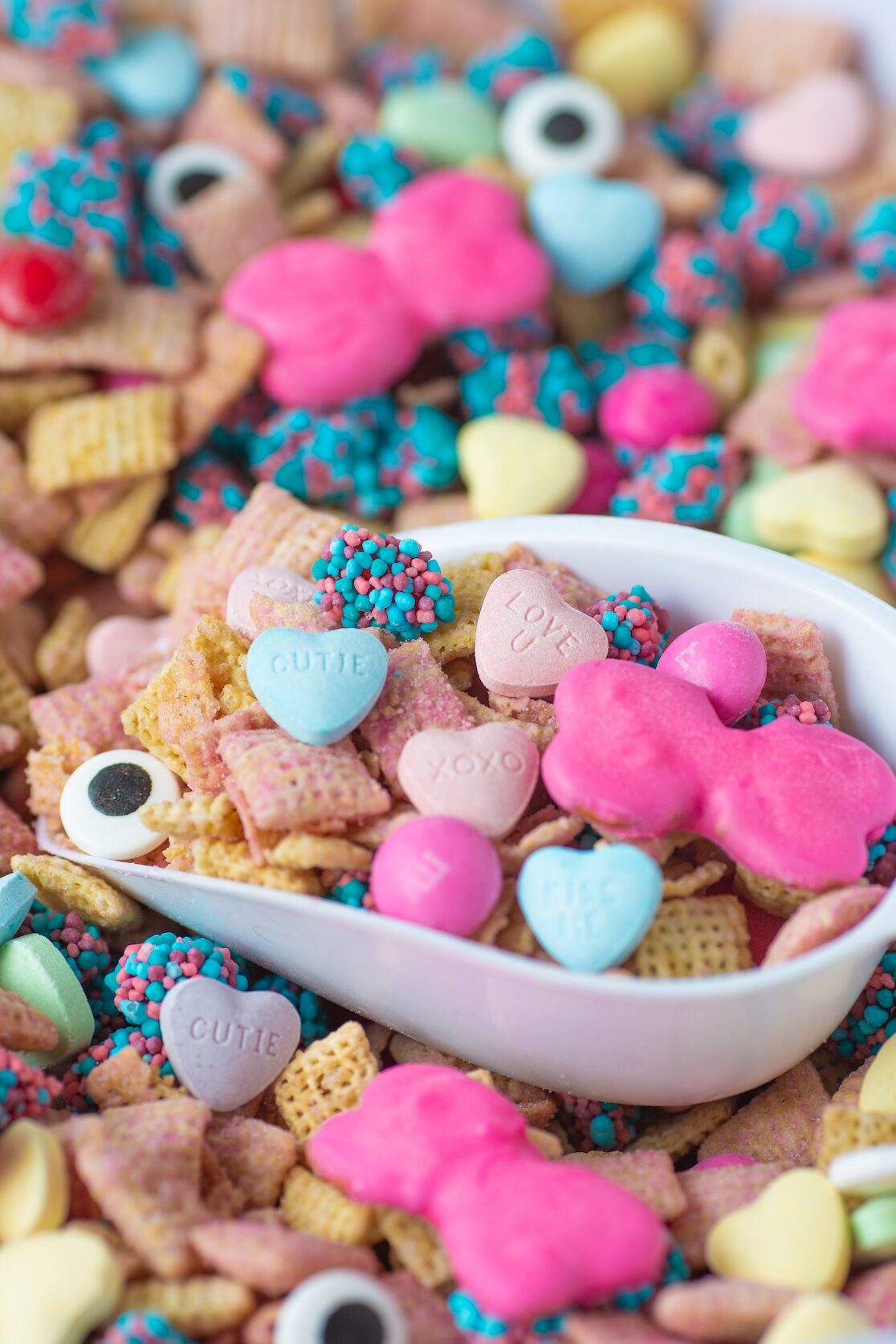 Monster High Snack Mix with pretzel bows in a bowl with a scoop to serve.