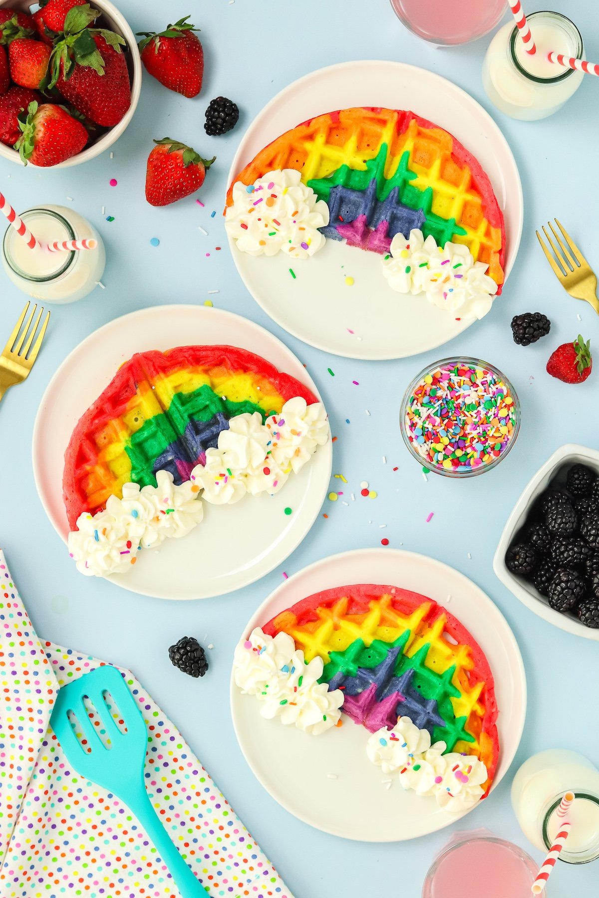 rainbow waffles on a plate with sprinkles