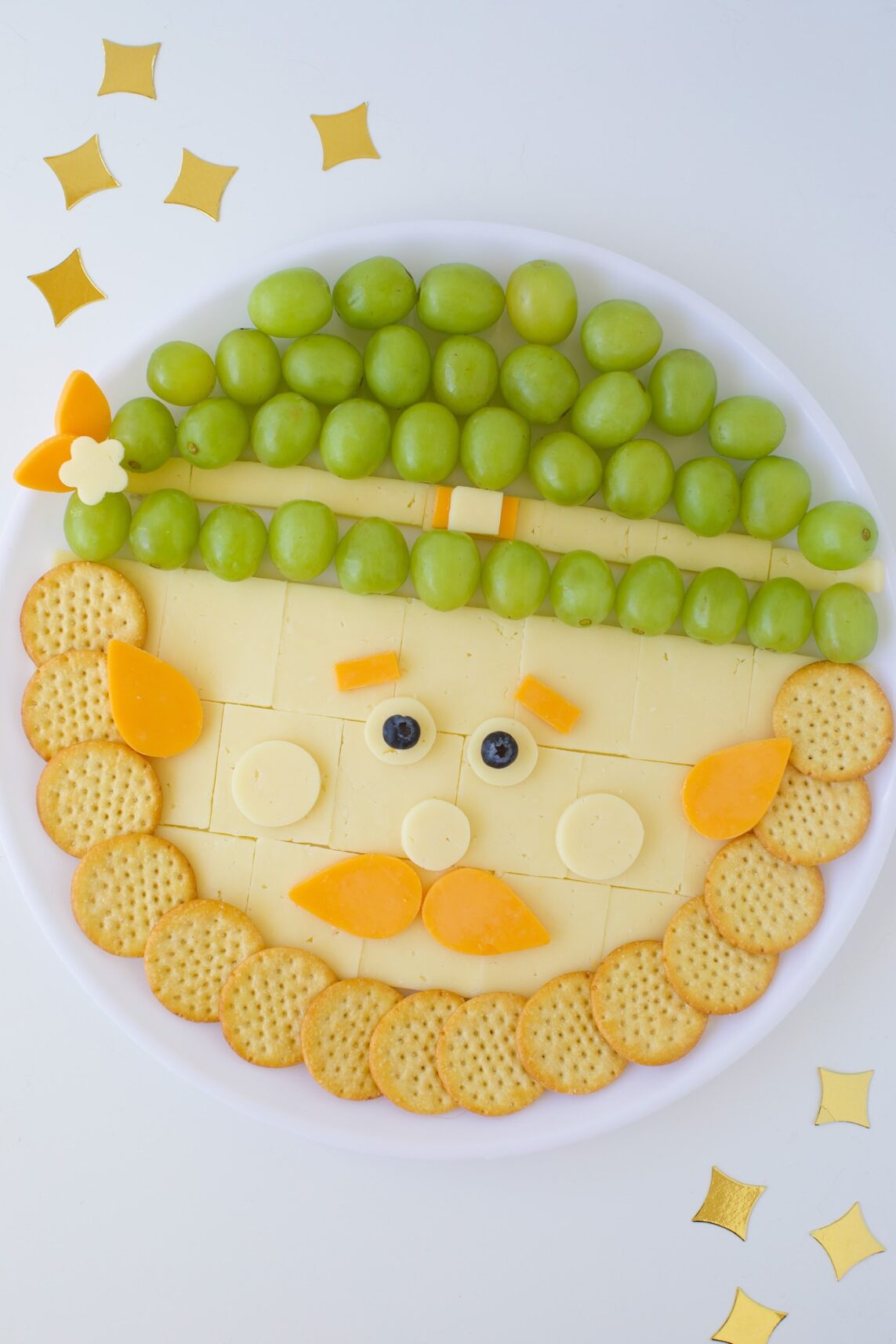 easy leprechaun cheese tray with grapes, cheese and crackers