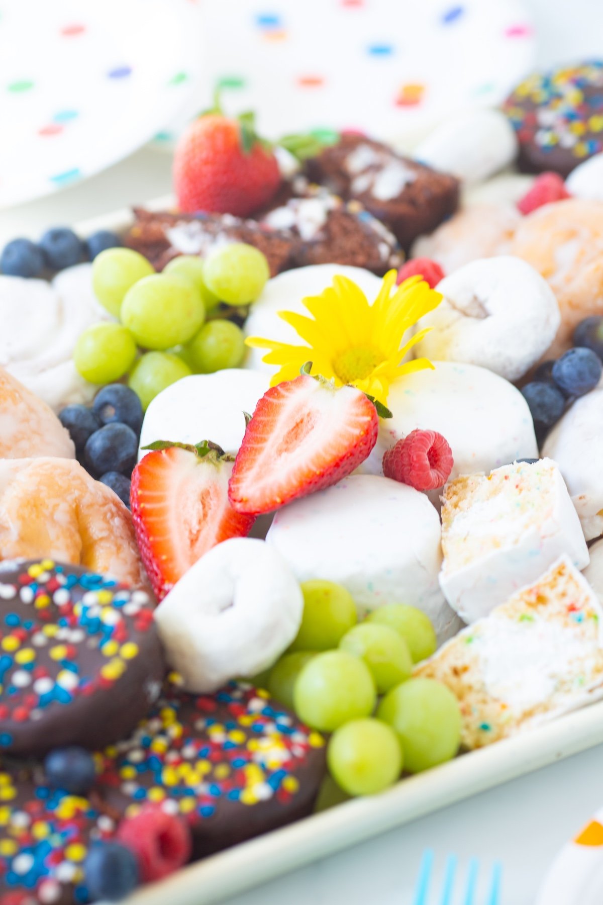 fruit and dessert board loaded with pastries and snack cakes from wonder