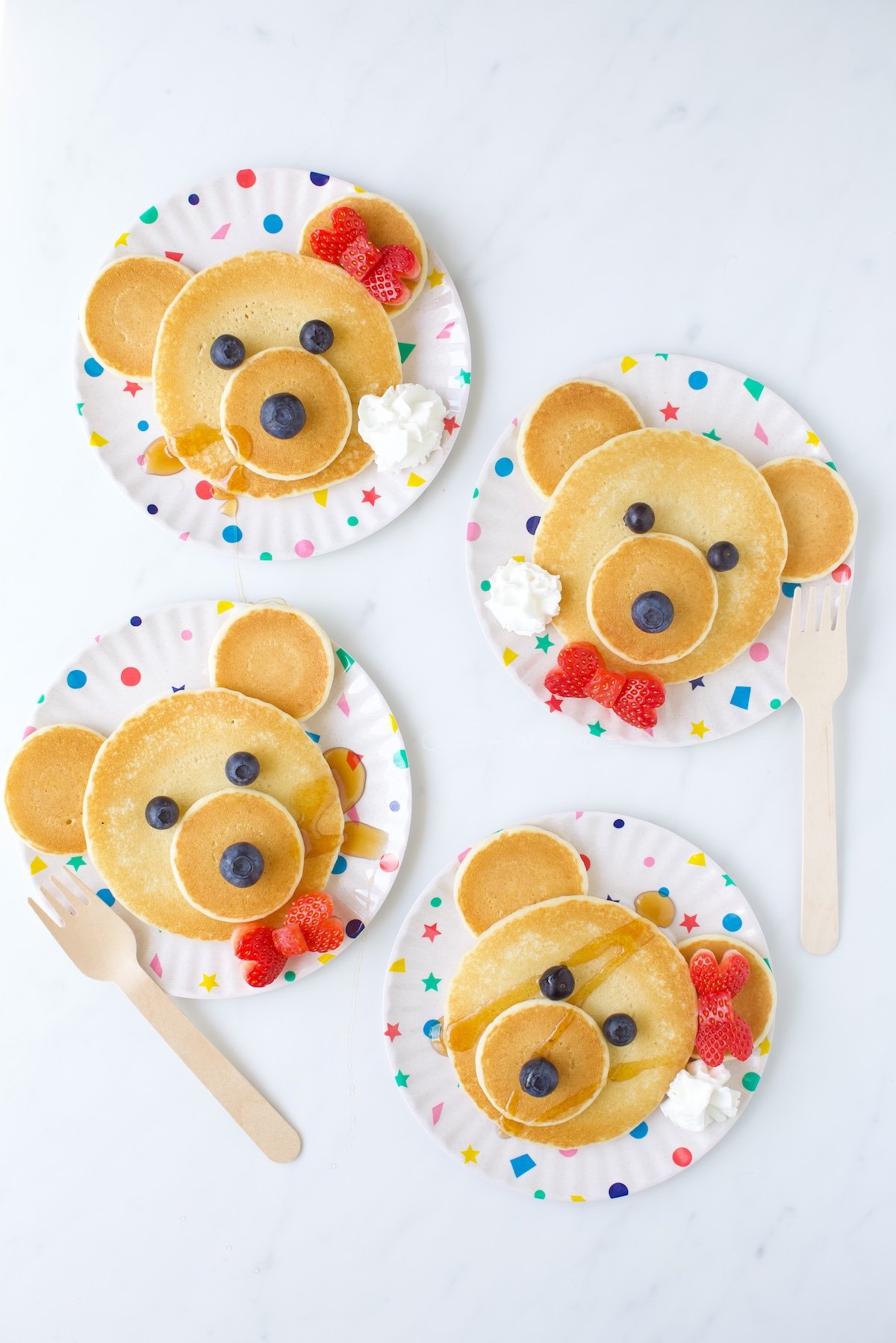 Adorable Teddy Bear Pancakes with hair bows and bowties made with strawberries