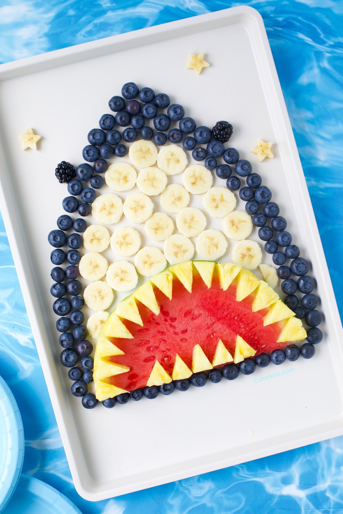 Shark make out of fruits like blueberries and bananas.