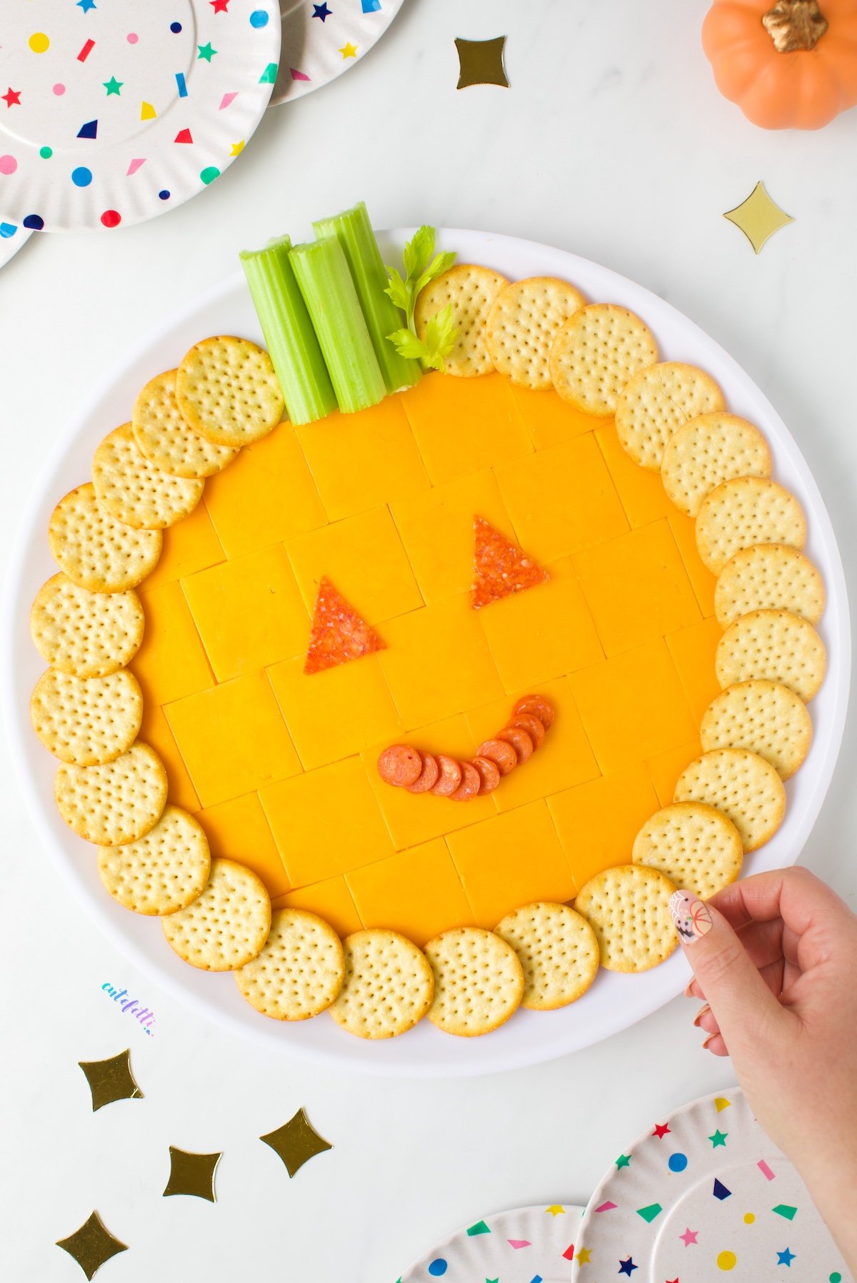 With cheddar cracker cuts, crackers, celery, and black olives, this pumpkin cheese tray is a party hit.
