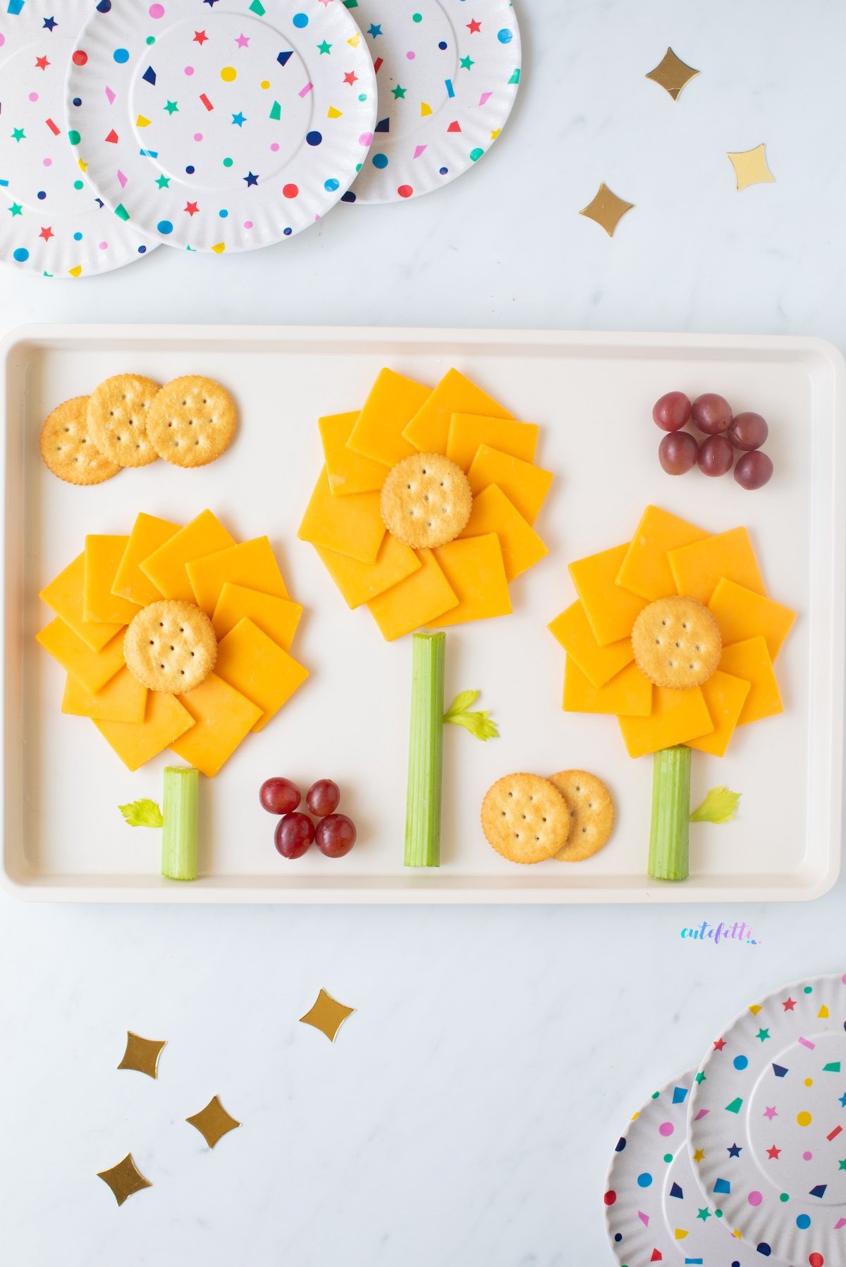 Sunflower snack trays with sharp cheddar, crackers served on a baking sheet
