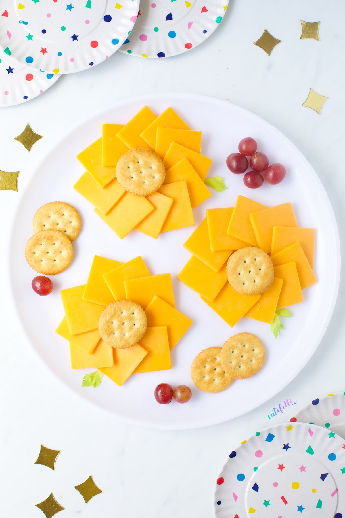 Sunflower cheese trays made on a round platter. Mini flower shapes made of cheese and crackers.