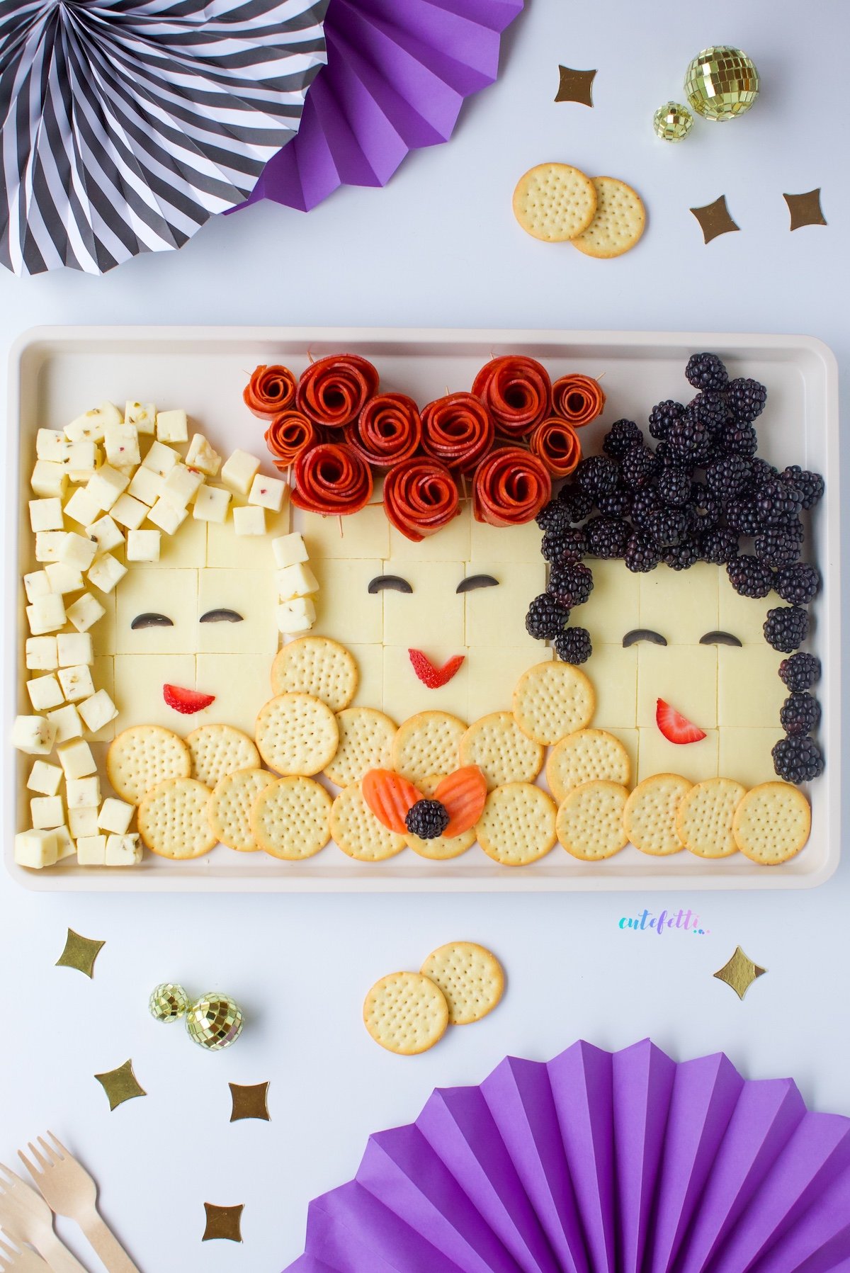 hocus pocus boards with cheese, crackers and fruits on a baking sheet.