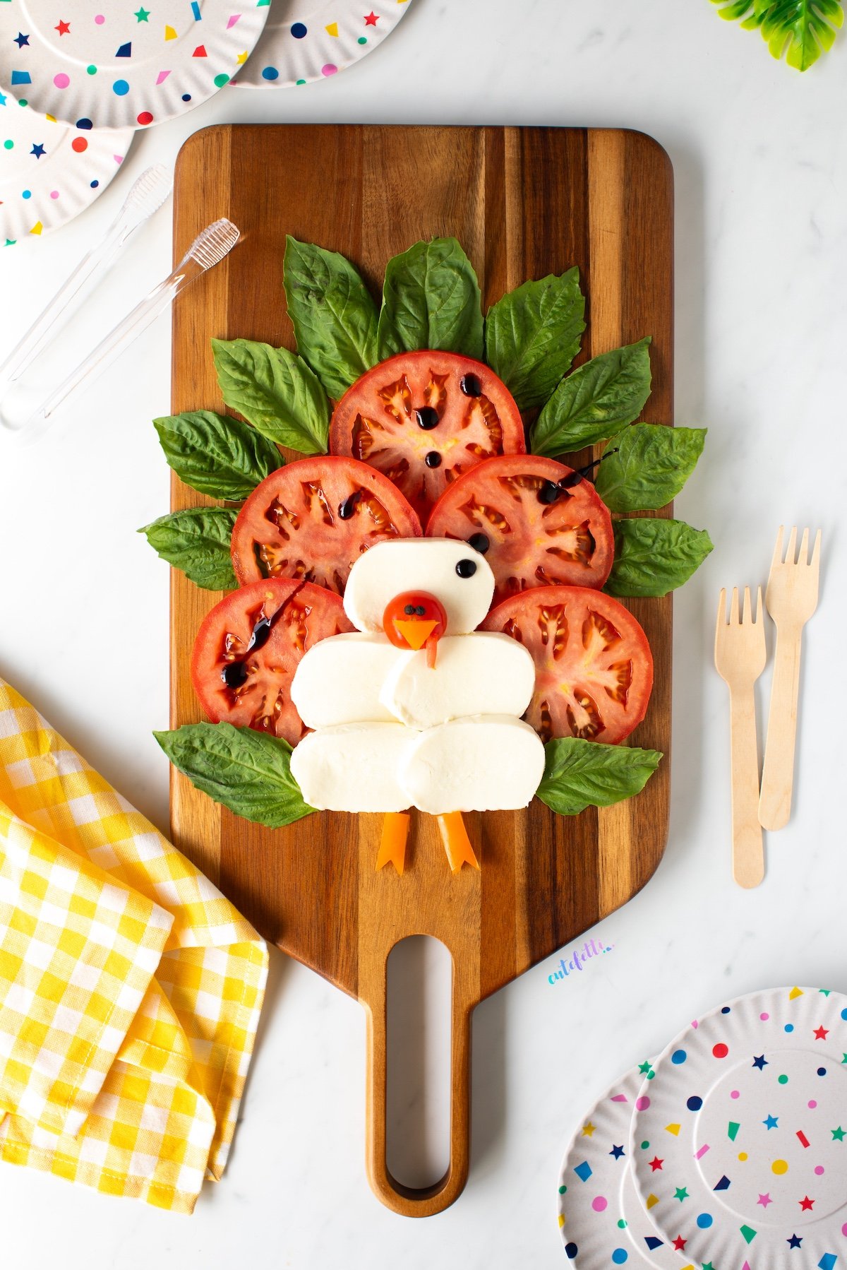 caprese turkey served on a wooden board for Thanksgiving