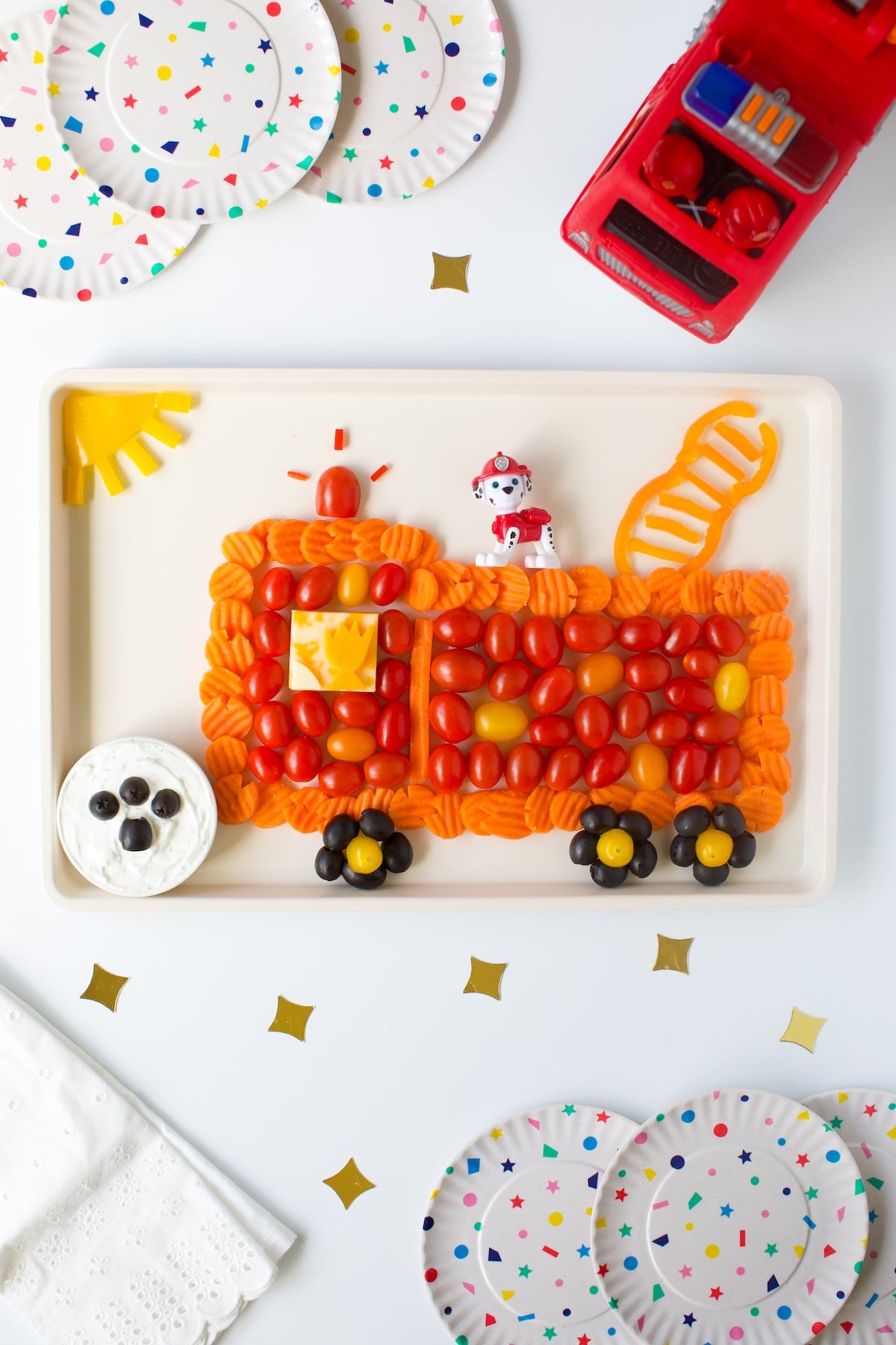 cute fire truck vegetable platter featuring PAW PATROL Marshall.