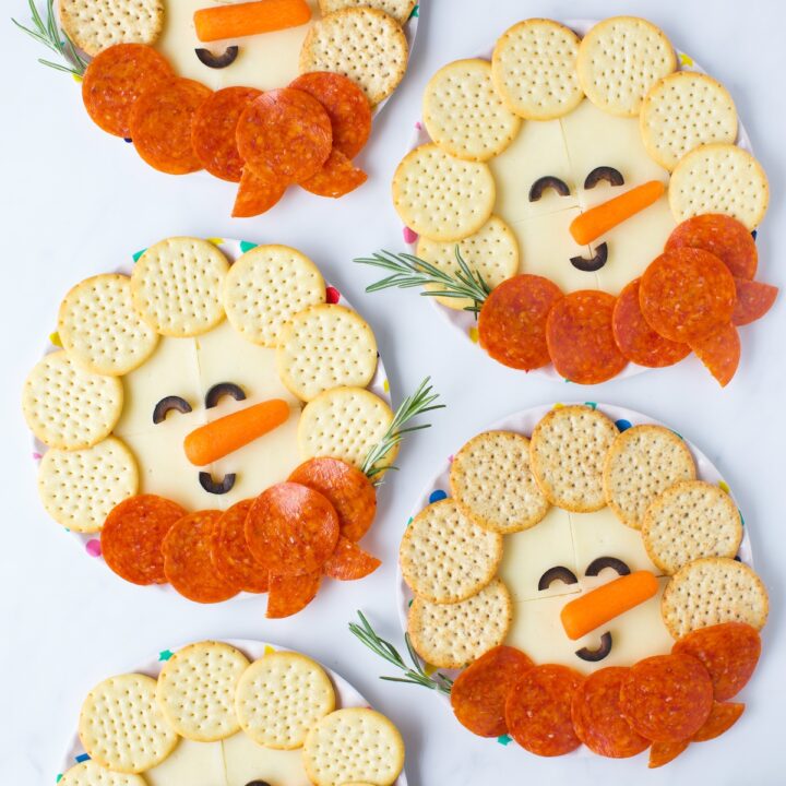 cute snowman snack plates made with cheese, crackers and pepperoni
