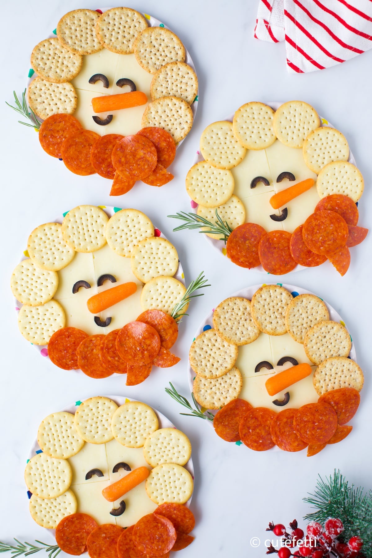 cute snowman snack plates made with cheese, crackers and pepperoni
