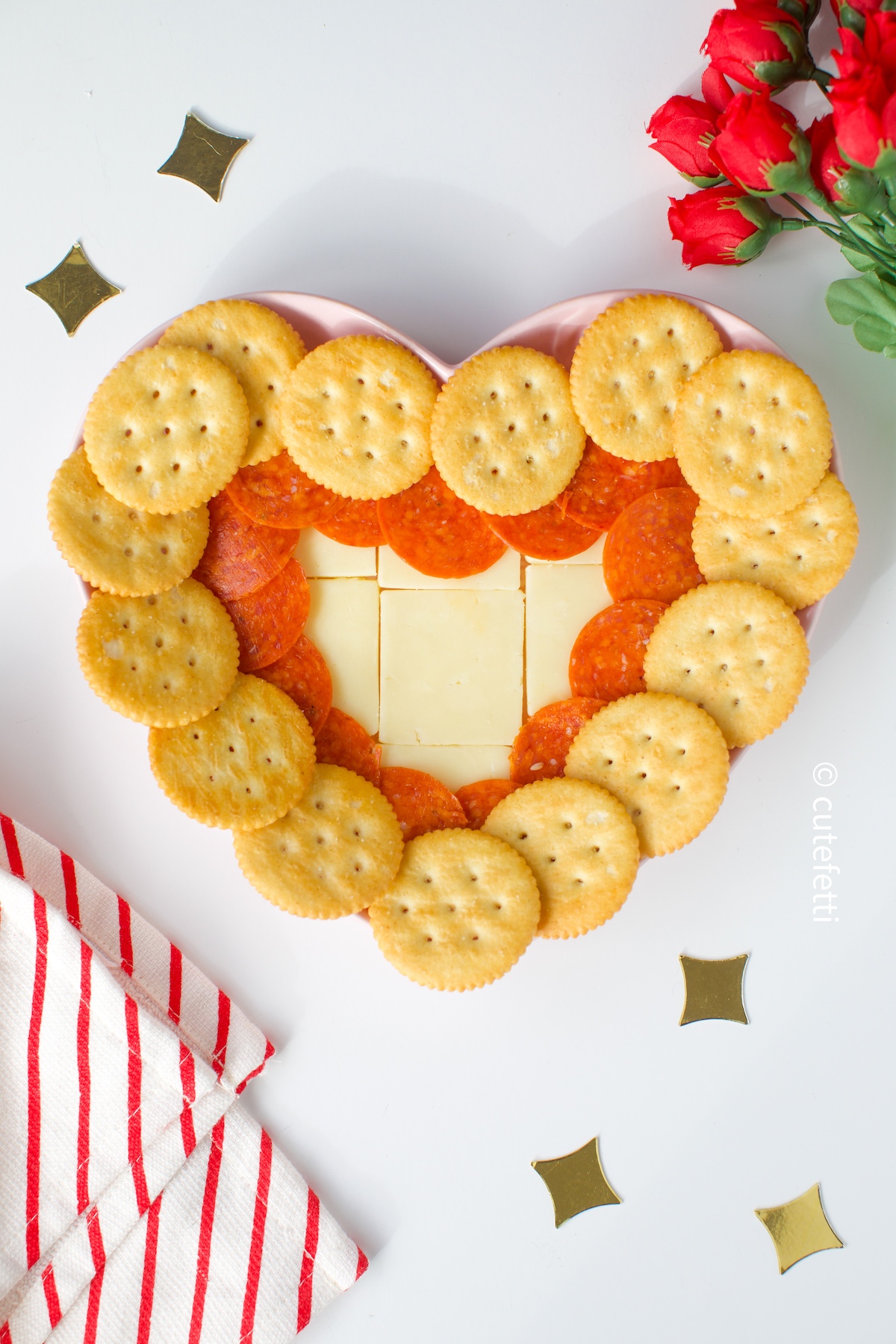 heart shaped cheese plate with pepperoni and crackers