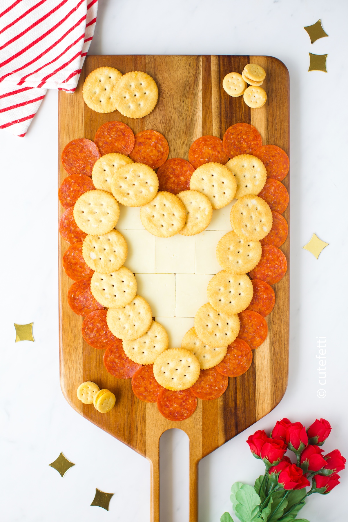 heart shaped board using pepperoni and cheese with butter crackers.