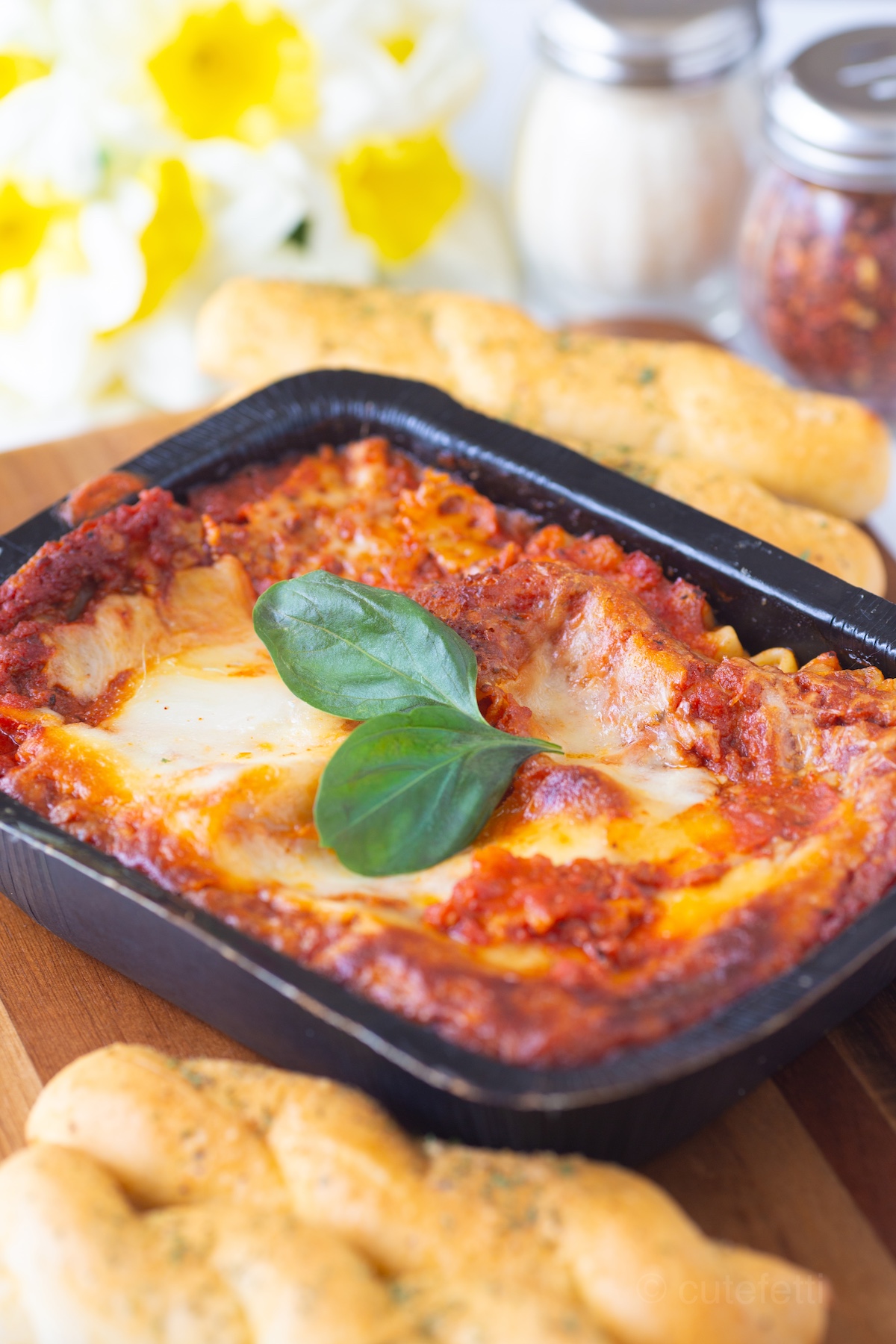 Michael Angelo's Lasagna with Meat Sauce prepared and served with breadsticks.