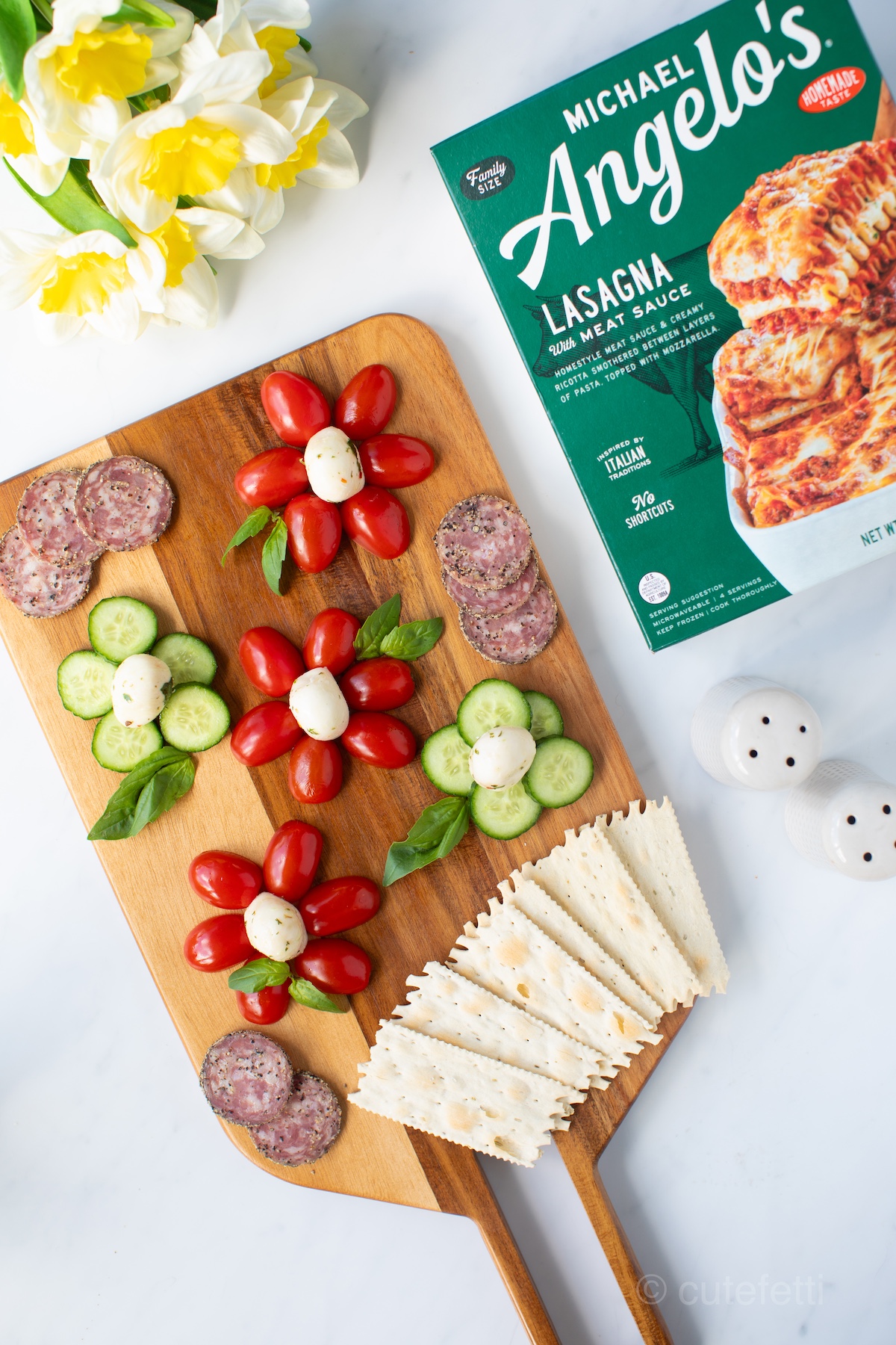 flower caprese appetizer with grape tomatoes, baby cucumbers, fresh basil and balsamic glaze.