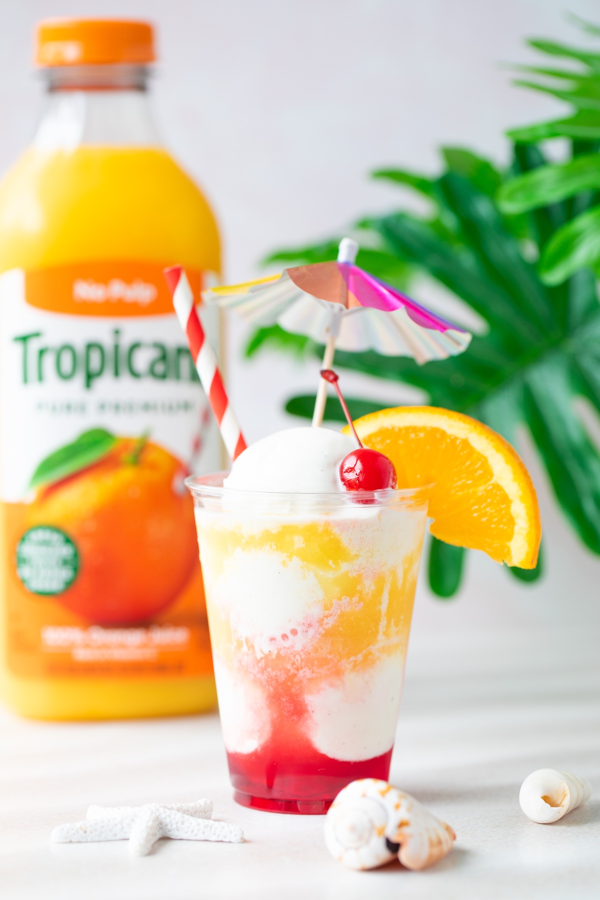 pretty sunset floats with oj, ice cream and cherry syrup.